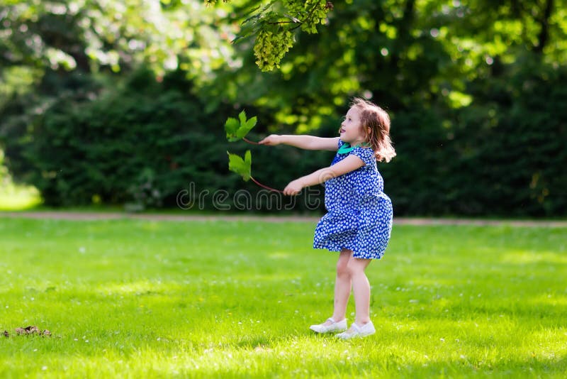 Little girl running in sunny park