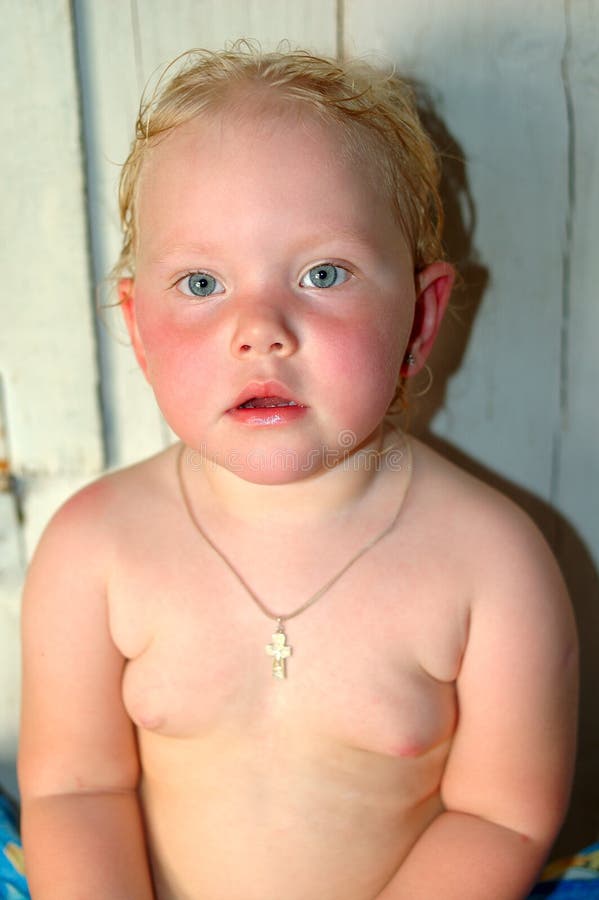 Little girl after Russian baths sit in bathhouse.