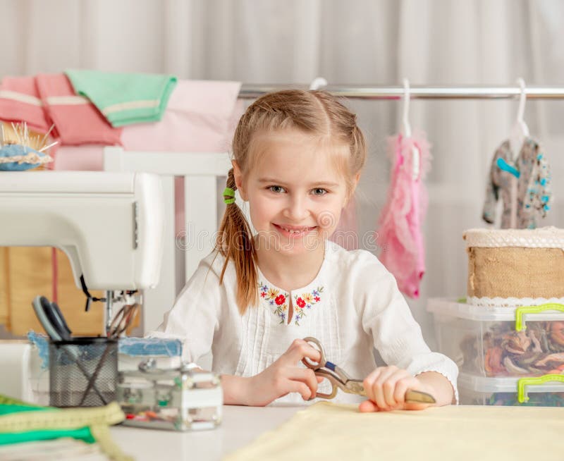 Little girl in a sewing workshop royalty free stock photos