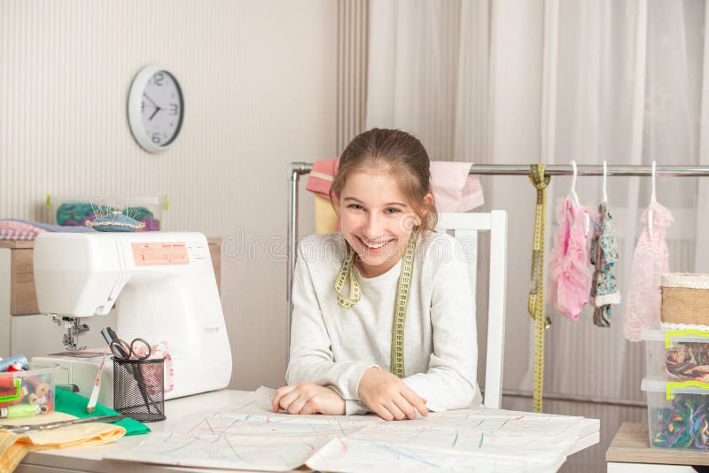 Little girl in a sewing workshop stock image