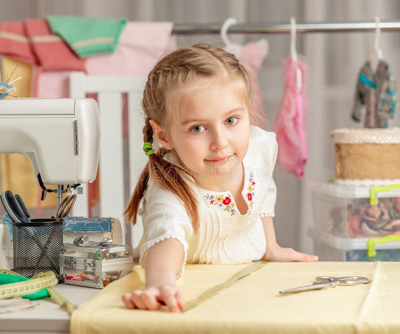Little girl in a sewing workshop royalty free stock images