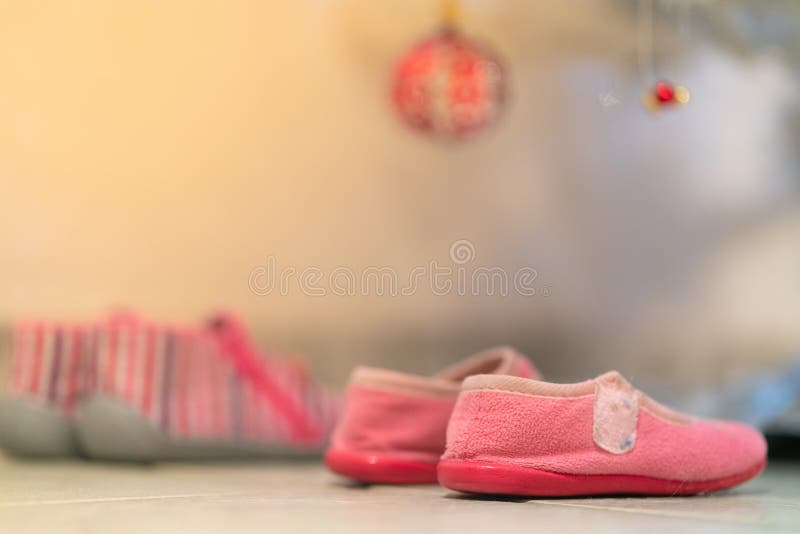 Little girl shoes under Christmas tree to receive presents