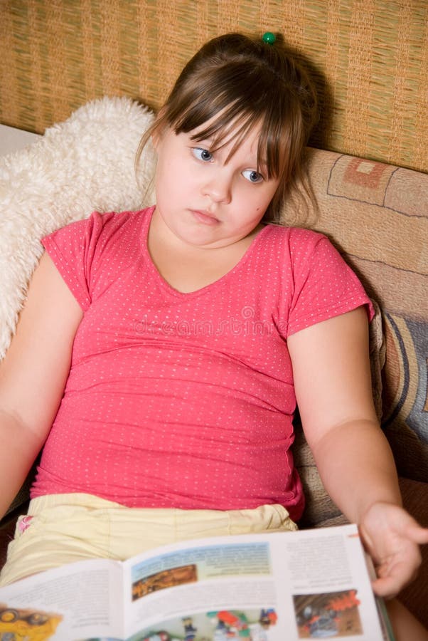 The little girl sits with the book