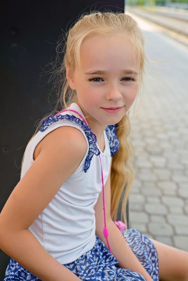 Little girl sitting on the bench