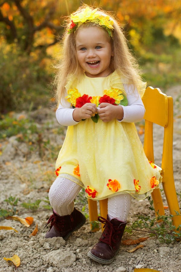 Little Girl is Sitting on Chair in Autumn Garden Stock Photo - Image of ...