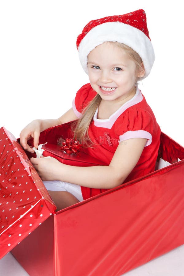 Little girl sitting in a Christmas box over white royalty free stock photos Little girl sitting in a Christmas box over white royalty free stock photos