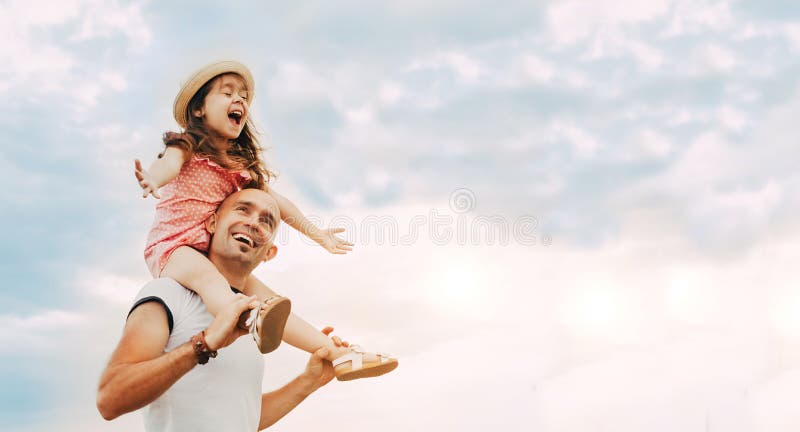 Little girl sitting on father`s shoulders stock photos Little girl sitting on father`s shoulders stock photos