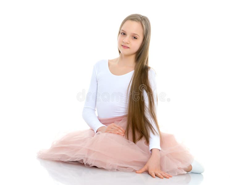 Little girl is sitting on the floor. stock photo