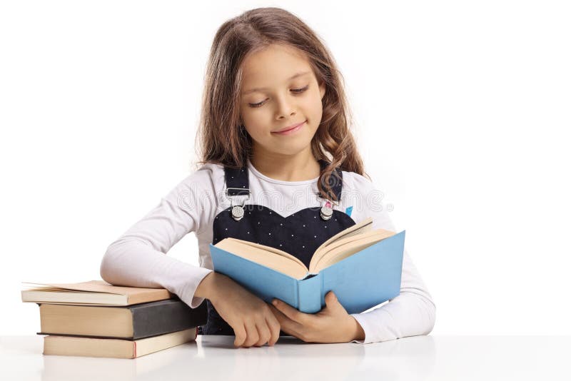 Little Girl Sitting at a Table and Reading a Book Stock Image - Image ...