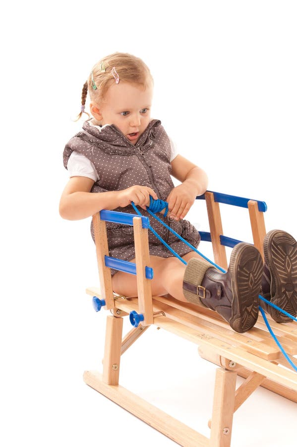 Little girl on sledge in studio