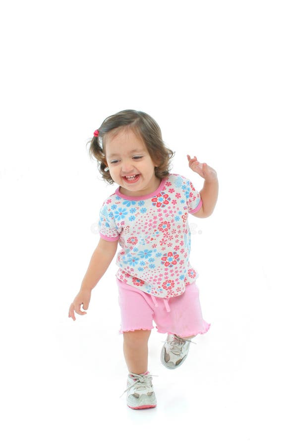 Little girl smiling and dancing stock photos