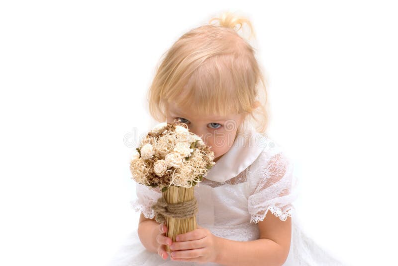 Little girl sniffing flowers