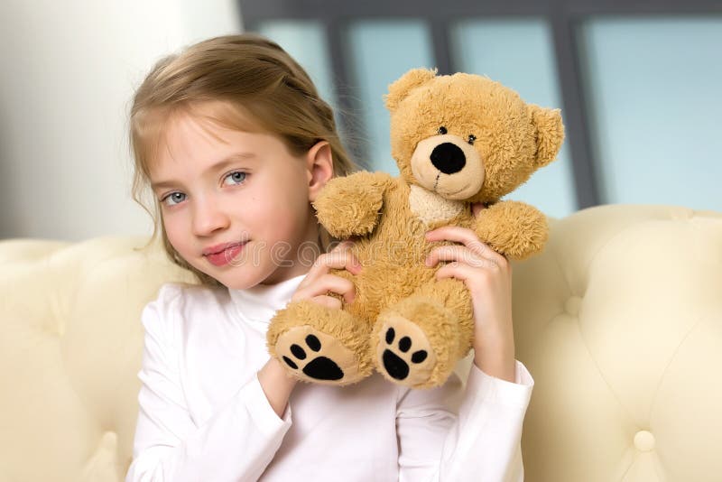 Little Girl on Sofa Hugging Teddy Bear. Stock Photo - Image of toddler ...