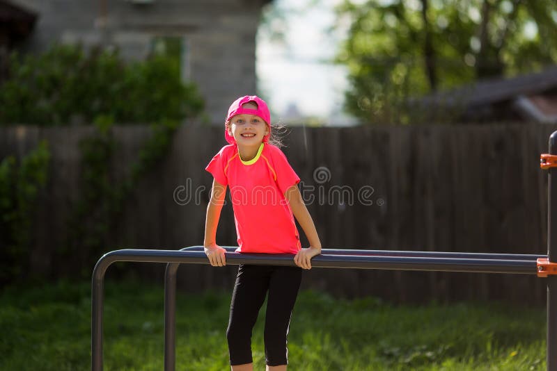 Little girl on a sports ground on the street leads a healthy lifestyle. In a healthy body healthy mind. Active lifestyle. Pretty royalty free stock photography Little girl on a sports ground on the street leads a healthy lifestyle. In a healthy body healthy mind. Active lifestyle. Pretty royalty free stock photography