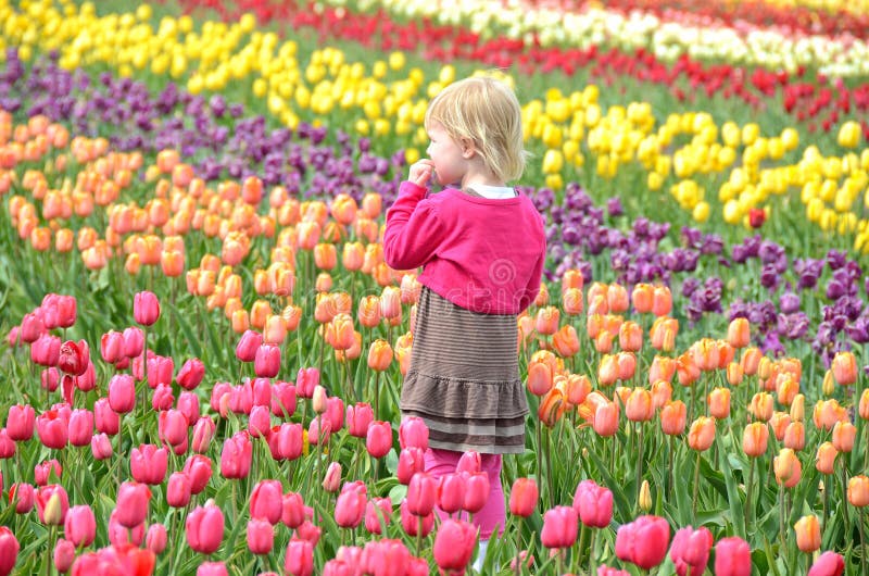 Little girl in spring tulips