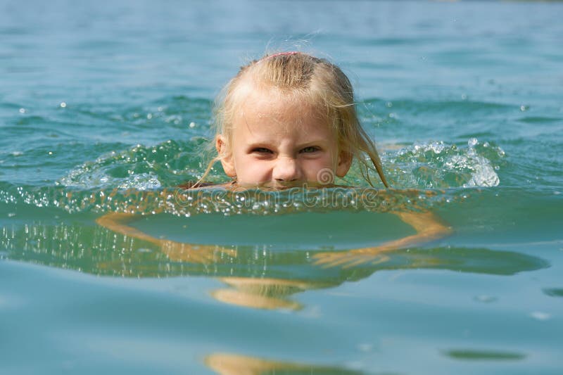 Little girl swimming in lake