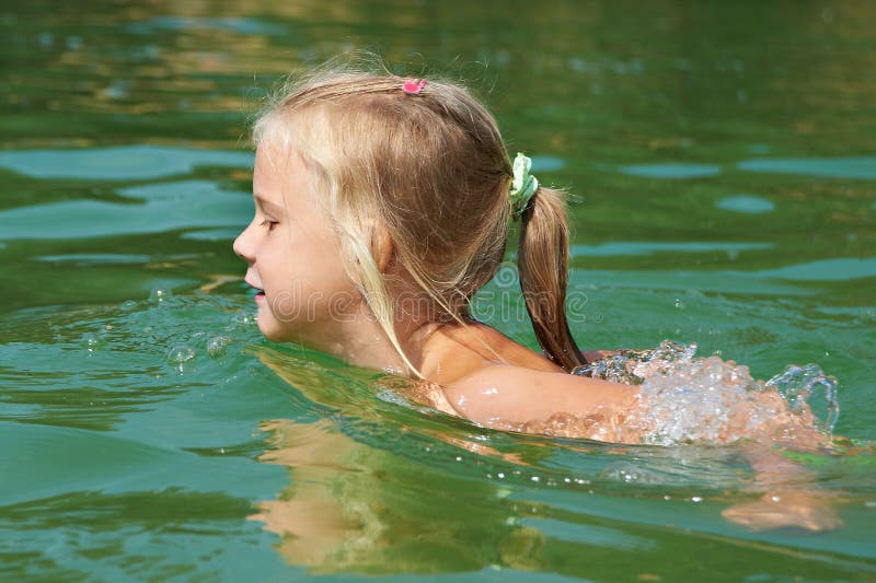 Little girl swimming in lake