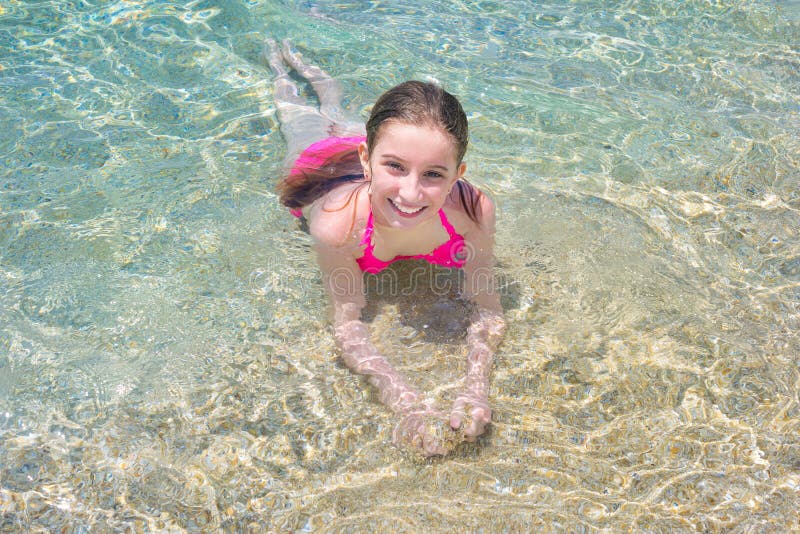 Little girl swimming in shallow water