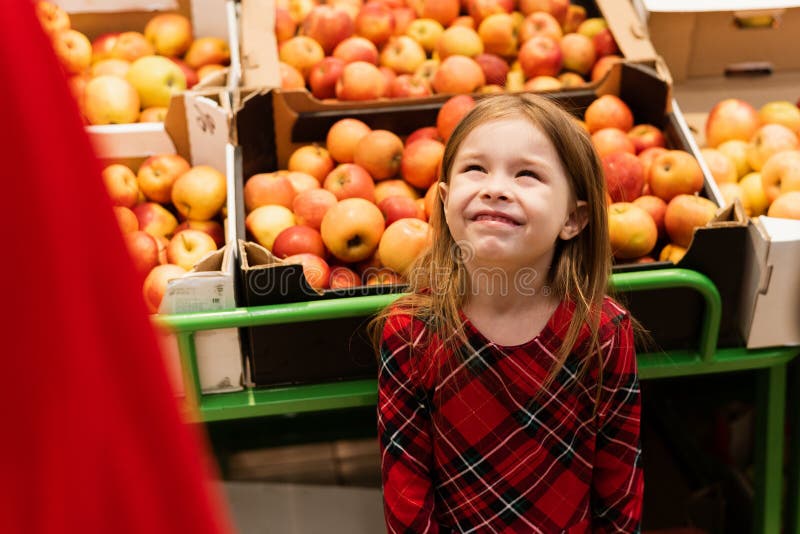 A little girl of about 5 threw a tantrum in a supermarket in front of her parents. The child screams and cries, begging sweets