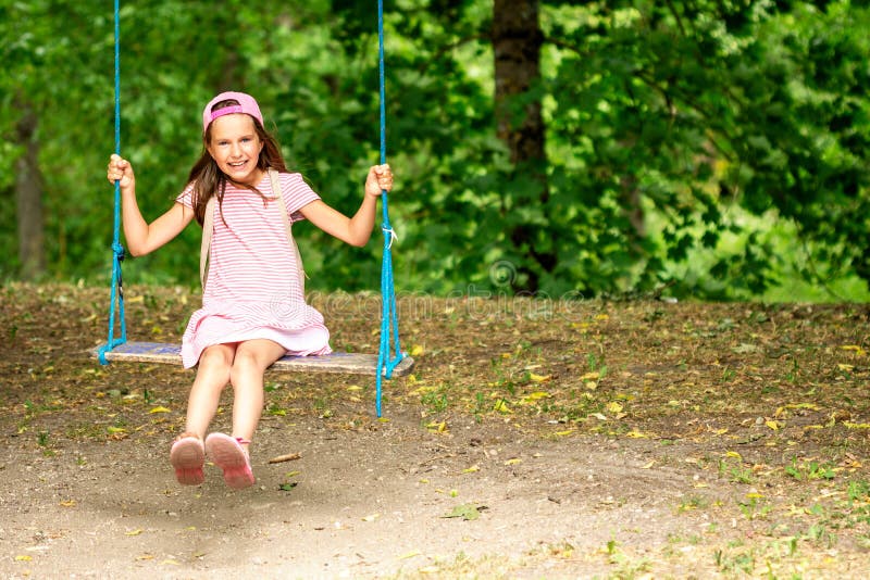 Little girl on the tree swing