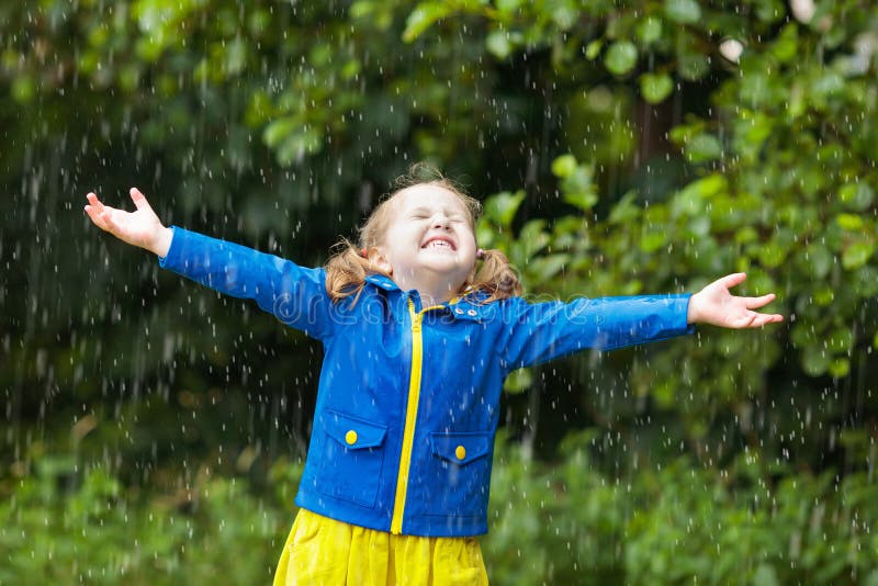 Little girl with umbrella in the rain