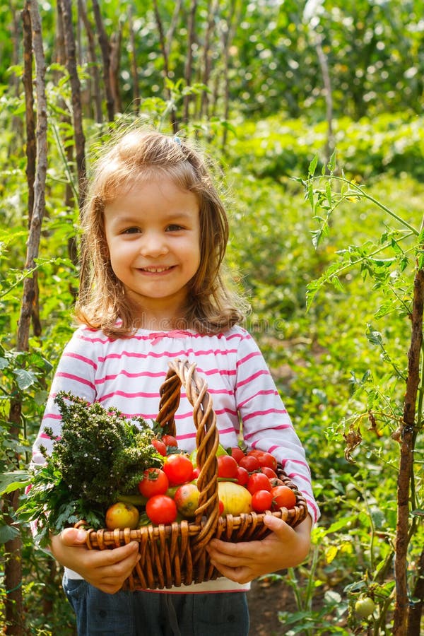 Little girl in a vegetable garden