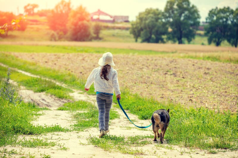 Little girl walk with dog