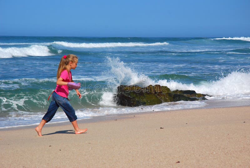 Little girl walking on beach