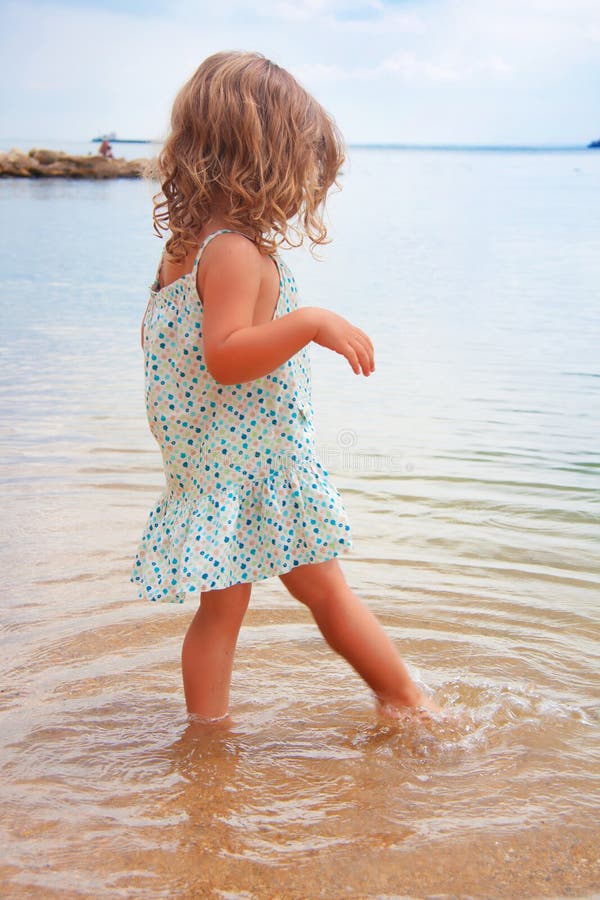 Little Girl Walking on the Beach Stock Image - Image of curly, beach ...