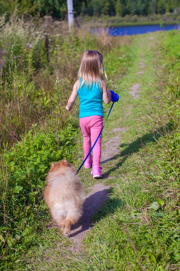 Little Girl Walking with Her ??dog on a Leash Stock Photo Image of