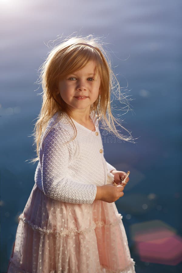 Little girl on the water background, portrait a sunny day royalty free stock photos Little girl on the water background, portrait a sunny day royalty free stock photos