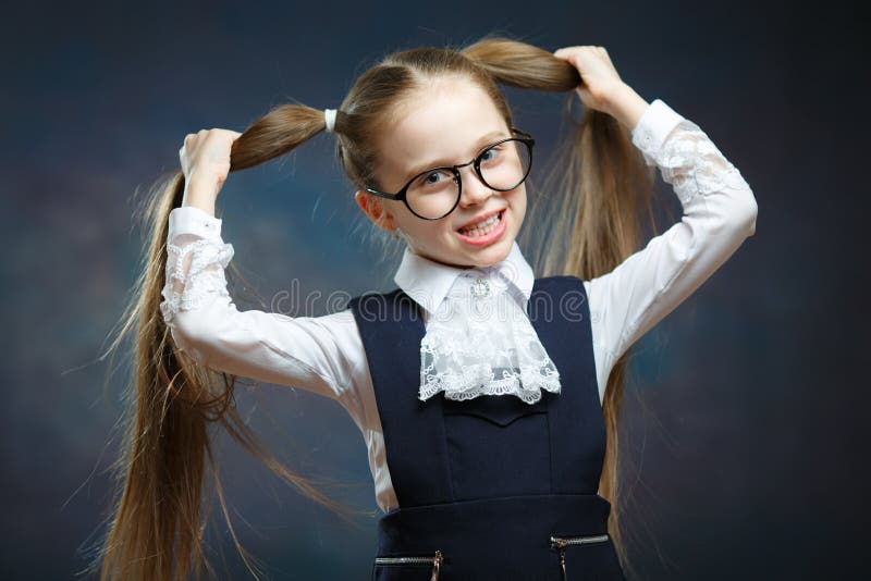 Little Girl Wear Glasses Look at Camera. Child Hold Hand on Ponytail