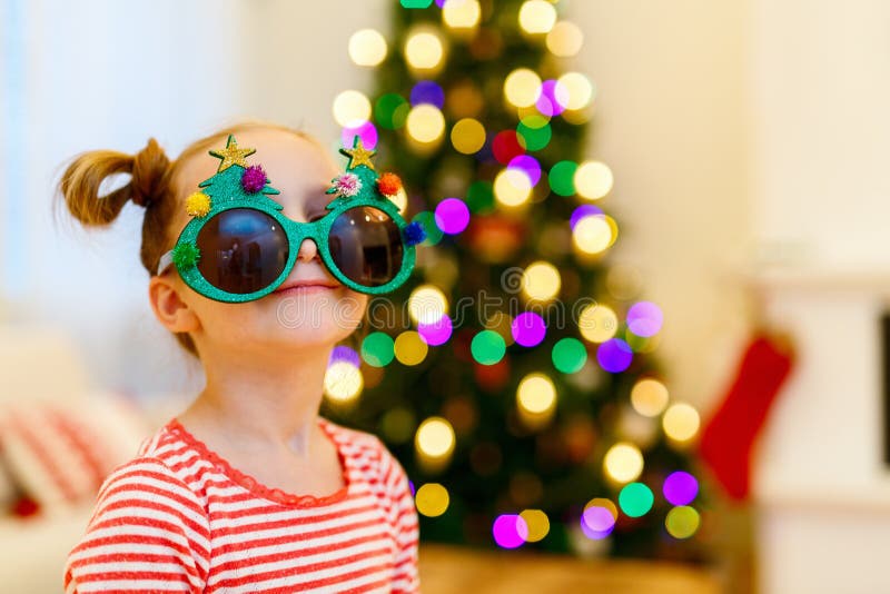 Little girl wearing funny Christmas glasses