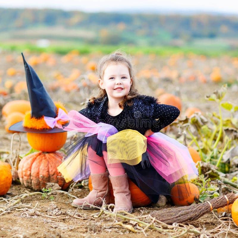 Little Girl Wearing Halloween Witch Costume on Pumpkin Patch Stock ...