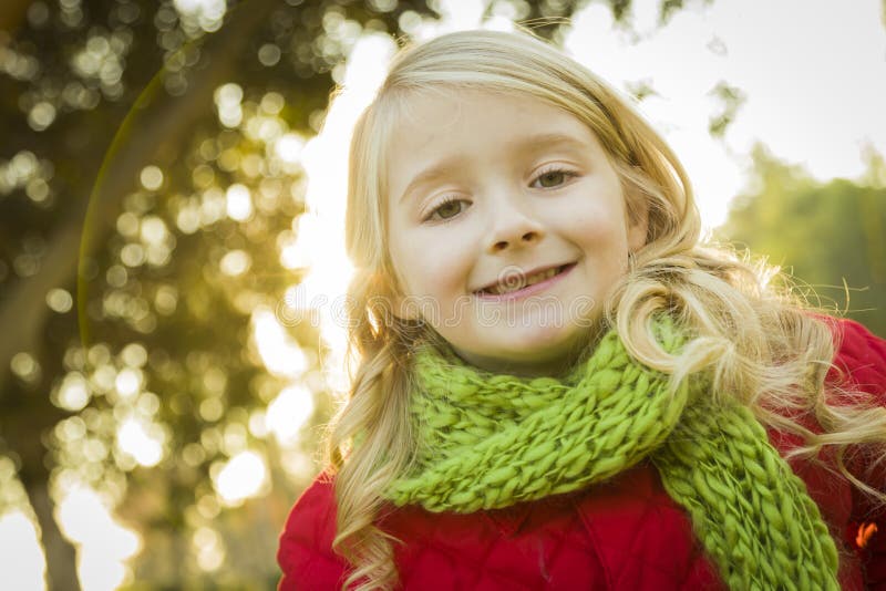 Little Girl Wearing Winter Coat and Scarf at the Park