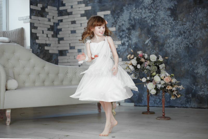 Little girl in white dress are dansing and moving stock image Little girl in white dress are dansing and moving stock image