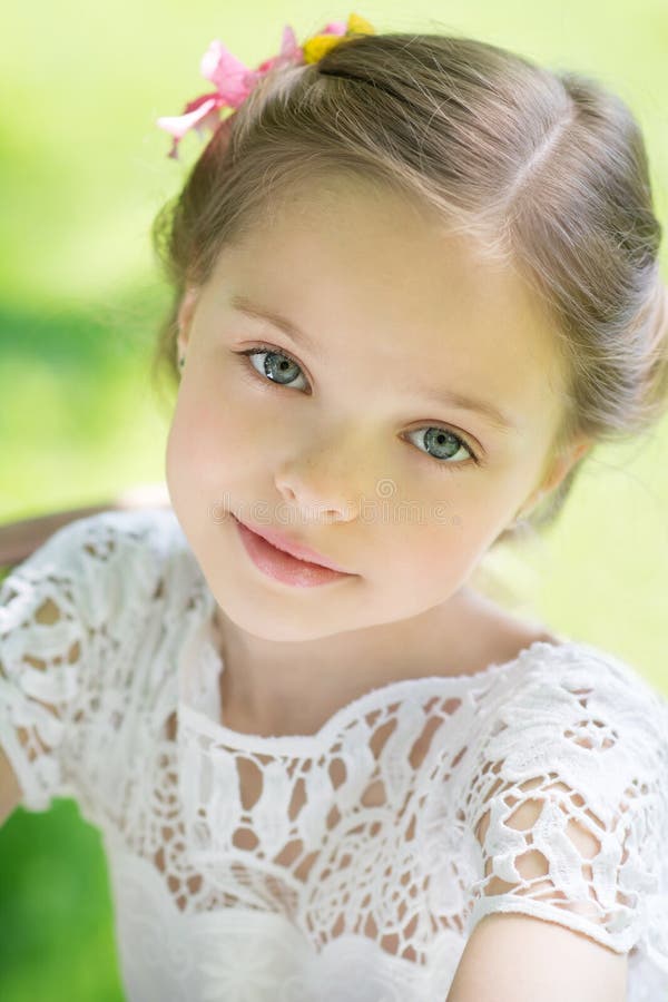 Little girl in white dress and flower.