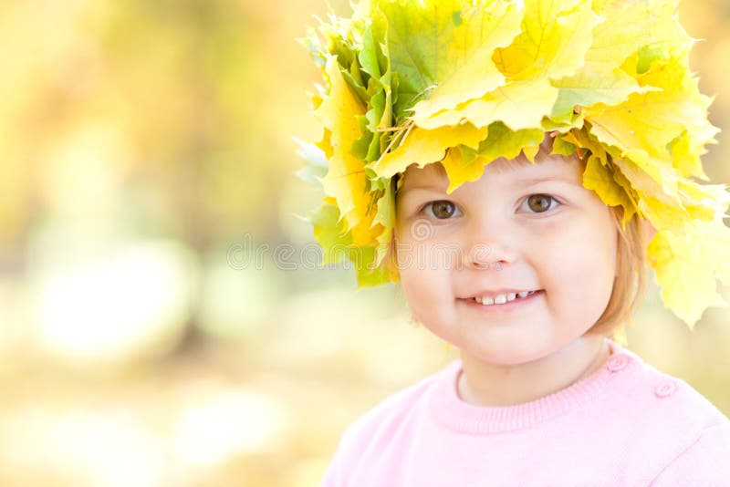 Little Girl in a Wreath of Maple Leaves in Autumn Fore Stock Photo ...