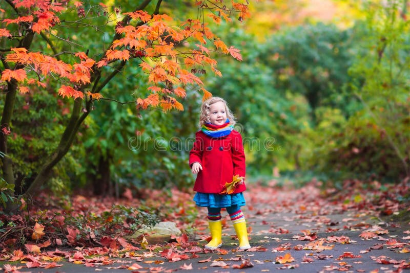 Little girl with yellow autumn leaf