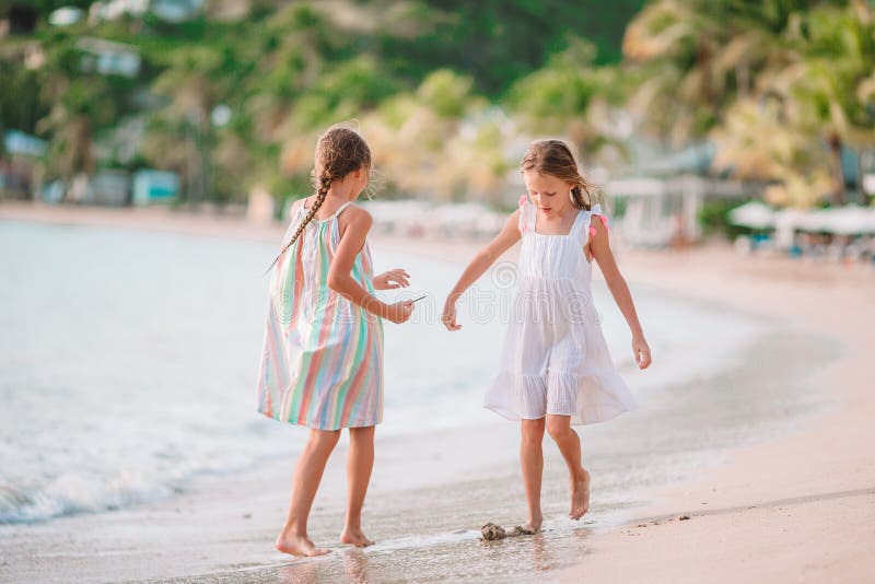 Little girls having fun enjoying vacation on tropical beach royalty free stock photos Little girls having fun enjoying vacation on tropical beach royalty free stock photos