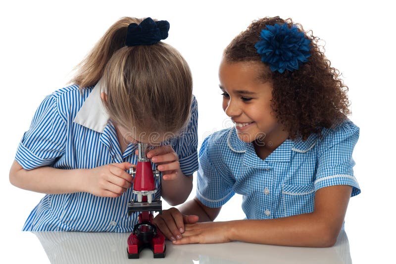 Little girls looking into microscope stock photo