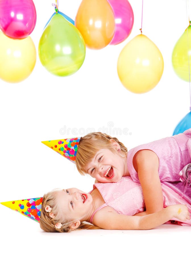 Little girls in party hats playing royalty free stock image
