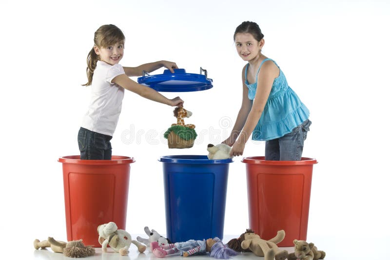 Little girls playing in a plastic drums