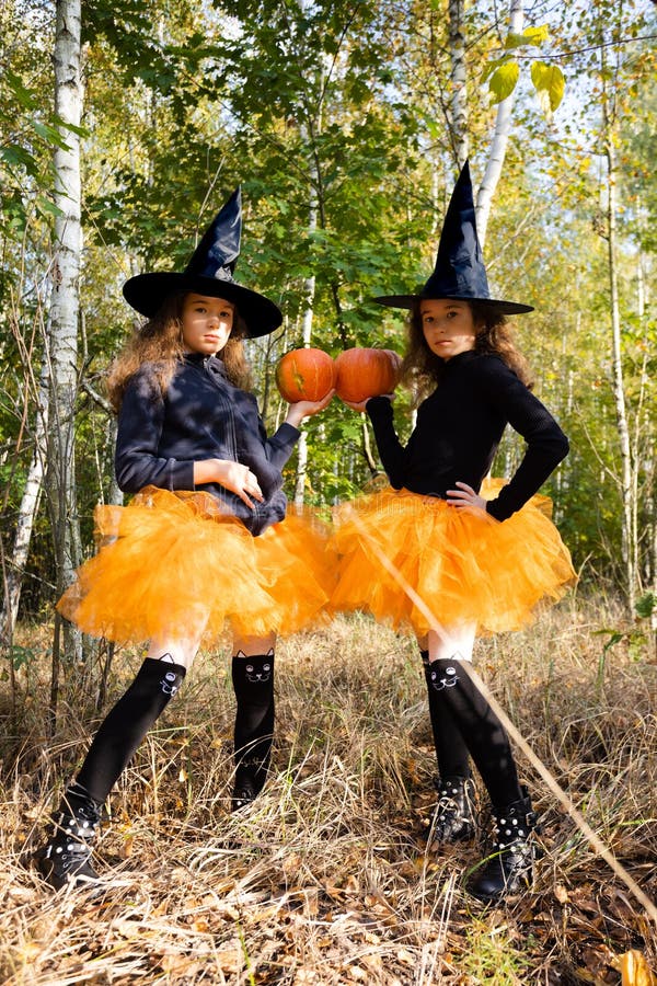 Little Girls Twin Dressed Like Witches in a Forest. Halloween Concept ...