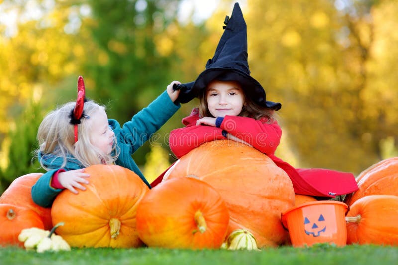 Little Girls Wearing Halloween Costume on a Pumpkin Patch Stock Image ...