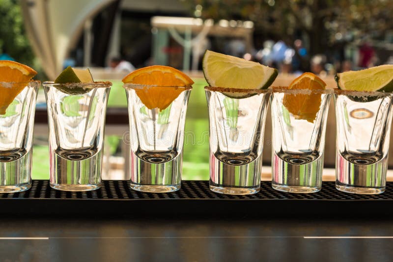 Little Glasses in Line with Orange and Lime Slices Ready to Tequila Shots royalty free stock photography Little Glasses in Line with Orange and Lime Slices Ready to Tequila Shots royalty free stock photography