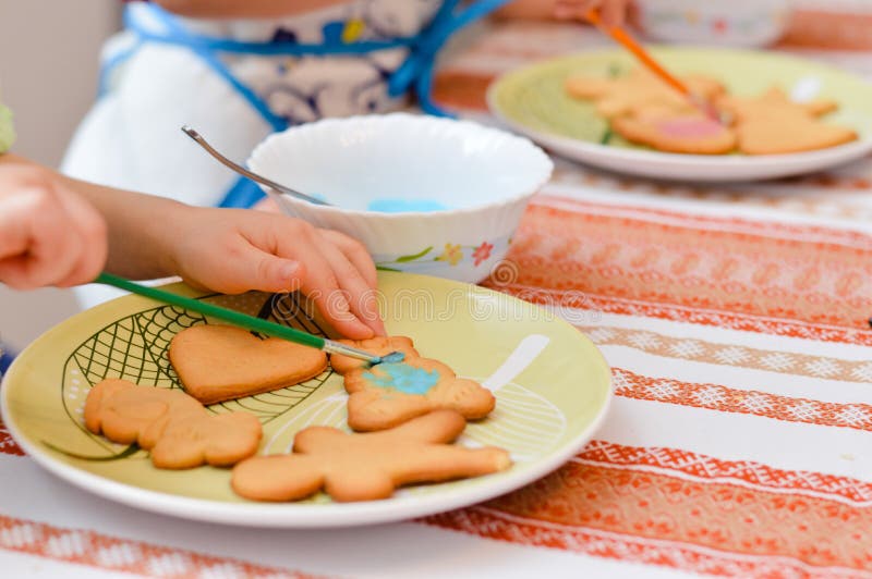 Little hands decorating the gingerbread cookies