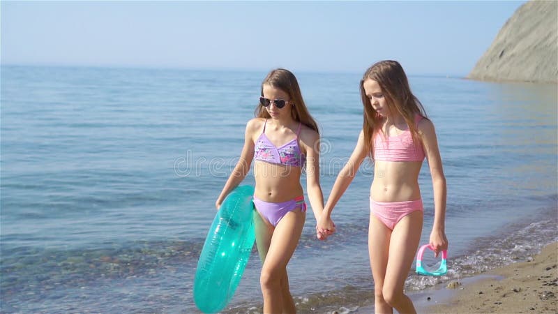 Little Happy Funny Girls Have a Lot of Fun at Tropical Beach Playing Together. Stock Footage - Video of kids, emotion: 193132800