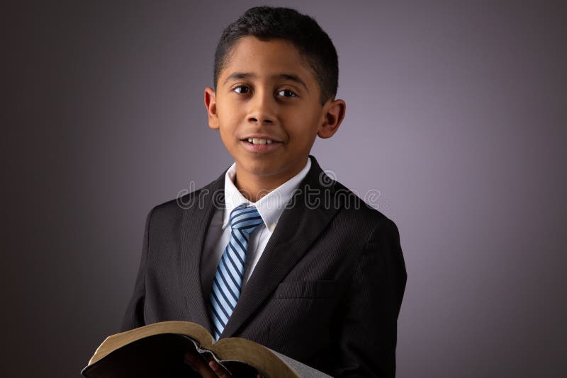 Little Hispanic Boy Holding the Holy Scriptures, The Word of God, The Bible