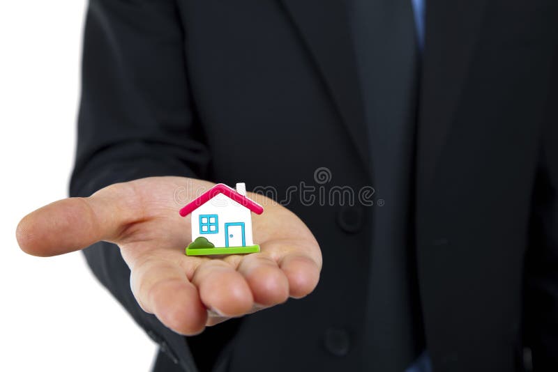 Little house symbol in hand stock photos